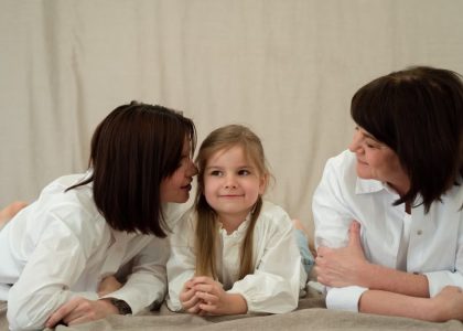 Three generations of women smiling together, symbolizing familial love and connection.